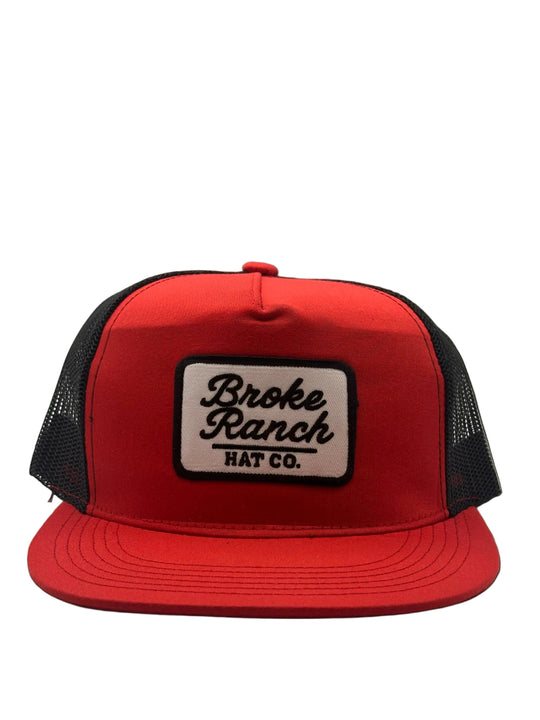 Red cap with a black and white logo on a light gray background